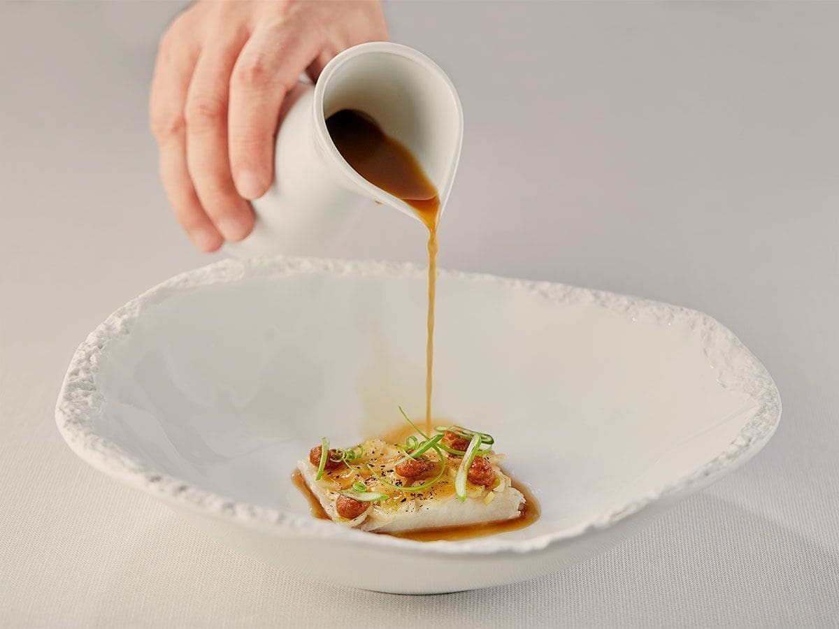 Fish with sauce on white dish 